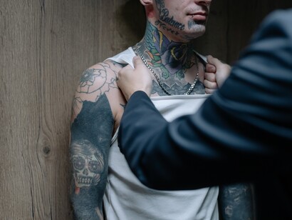 Homem executivo segura homem tatuado em briga