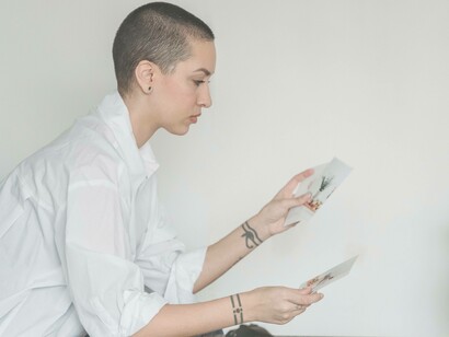 A woman comparing the pictures and taking into account the different angles