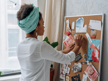 A woman gathers curated lifestyle images to create her own inspiration board