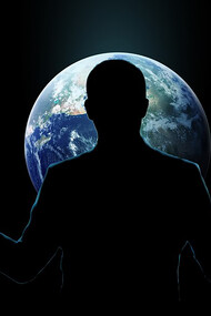 A man with open hands standing behind a globe, symbolizing global care and responsibility