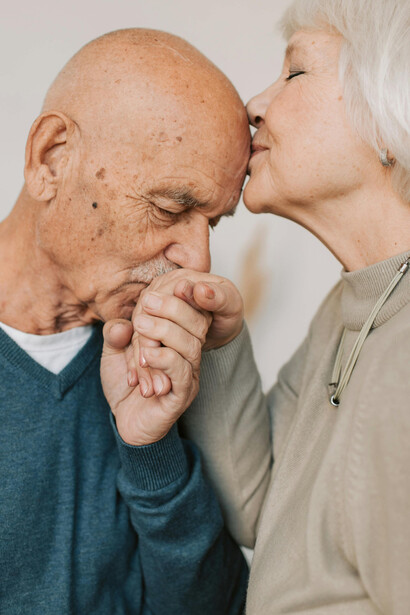 A loving elderly couple holding hands, reflecting intimacy and a deep emotional bond