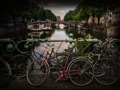 Amsterdam, Netherlands, is a huge bicycling community, as bicycles line the bridge over the canal