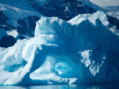 Sculpted Antarctic ice extending into the sea, symbolizing the environmental and strategic importance of the polar region