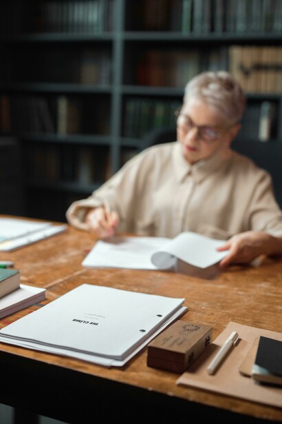 A woman proofreading a manuscript or an editor reviewing a draft