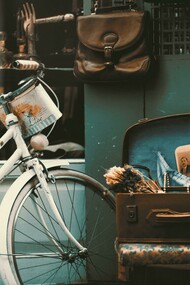 A vintage bicycle rests outside a charming shop, evoking a sense of classic beauty