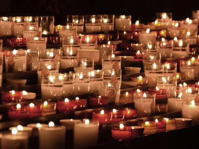 Rows of white and red candles in glasses