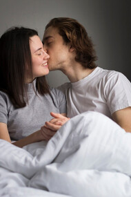 A couple in their bedroom sharing a moment of intimacy, a reminder that affection, legality and consent must go hand in hand 