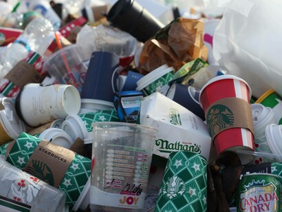 Plastic cups and containers huddled up together as a sign of male toxicity crippling the environment and causing climate change