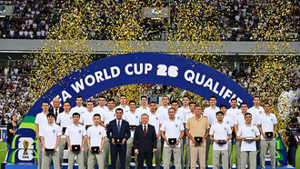 Uzbekistan’s national football team poses with the country’s president after the match against Qatar on June 10, 2025