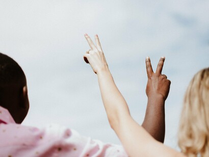 Man and woman flashing peace sign