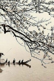 A Chinese fisherman crossing the water with his boat