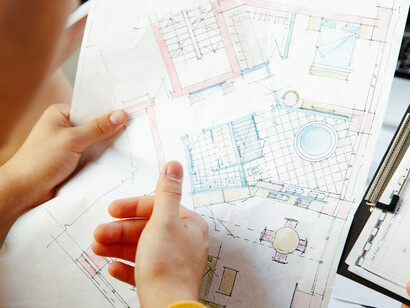 An architect is diligently working on a project design, showcasing innovative concepts and creative solutions for modern urban environments