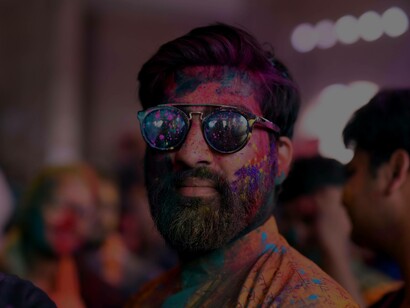 Man covered in paint paying homage to his culture at a festival in Pakistan