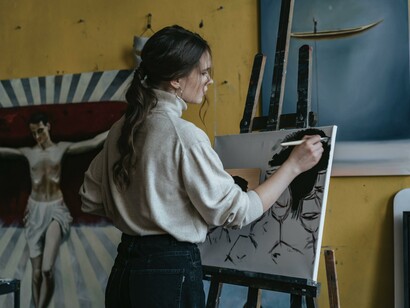 An artist painting in her studio. A purpose is unique if you consider why you were sent to this planet