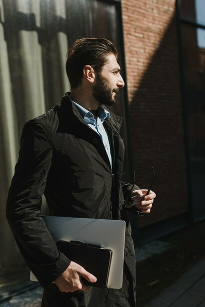 Businessman holding a laptop and notebook