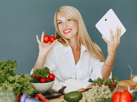 A woman prepares a vibrant salad with avocado, omega-3-rich foods, and probiotic ingredients, focusing on gut health and cognitive function