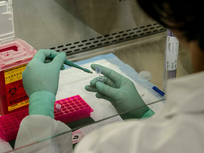 A concentrated female scientist carefully conducting an experiment in a laboratory setting