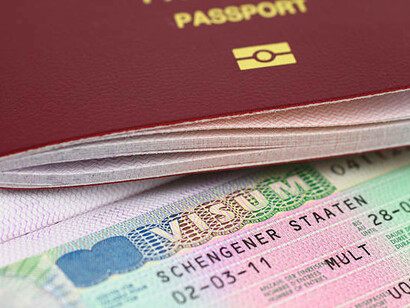 A close-up of a Schengen visa and passport photo, reflecting the freedom of movement within the European Union and Schengen Area