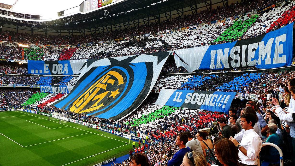 Inter, curva di tifosi allo stadio. I trionfi dell'Inter nella stagione 2024, inclusi i trofei conquistati nella Supercoppa e nella Coppa Italia, che hanno consolidato il loro status di élite nel calcio italiano