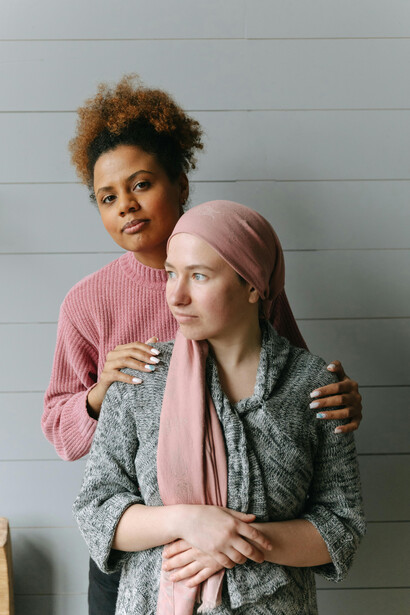 Women supporting each other through illness, a gesture of hope and friendship