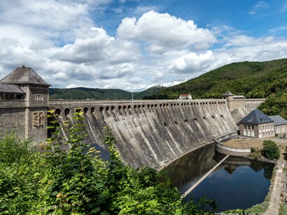 A dam controlling water and generating energy, representing the scale of infrastructure required to support modern societies