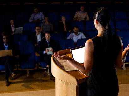 A female politician delivering a speech, symbolizing democracy, voice, and representation