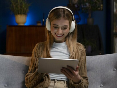 A woman streaming content on a tablet, reflecting how platforms gather insights from everyday user interactions