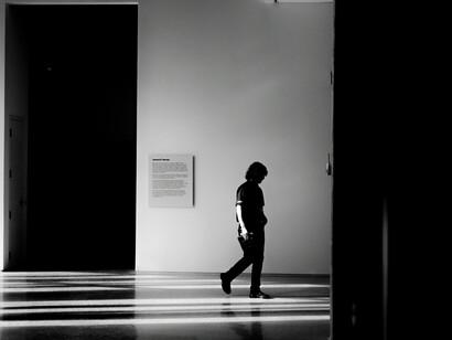Black-and-white conceptual photography of a person surrounded by an expansive empty space, creating a striking atmosphere of solitude and introspection