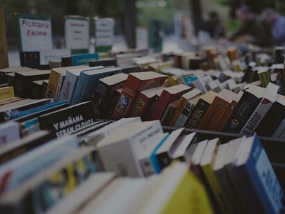 Rows and rows of books at a market that could easily be found at the library