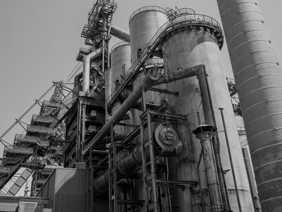 Low-angle view of a manufacturing facility set against the sky