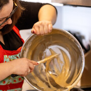 Andrea pours the batter for honey cake, a Jewish New Year tradition. Courtesy of Ingenium. The Canada Agriculture and Food Museum. Photo by Lisa Milosavljevic