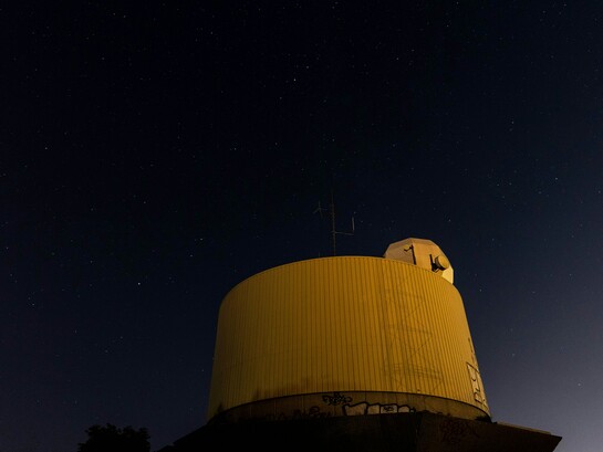 A lone observation setup under the night sky captures the quiet, methodical search for unidentified aerial phenomena
