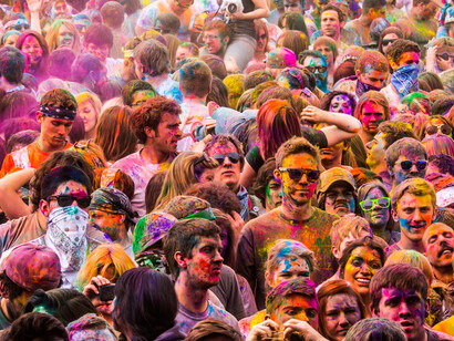 The dense crowd at this event underscores how societal trends and collective behaviors often lead people to embrace popular activities without fully evaluating their true value or necessity