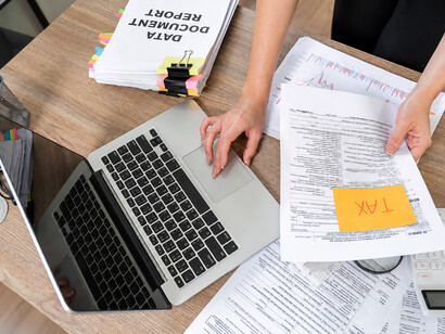 Accountant analyzing financial reports and preparing tax documentation