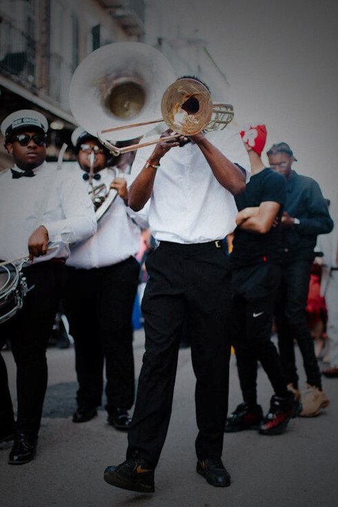 People watching musicians perform at a street festival in New Orleans, USA