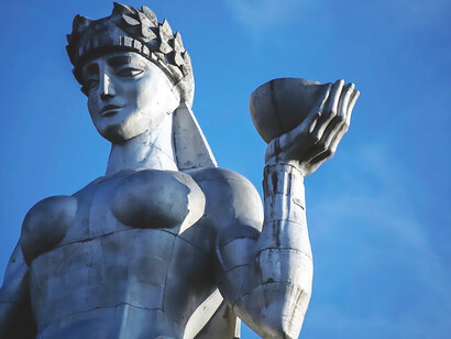 Kartlis Deda, the iconic Mother of Georgia statue, proudly stands overlooking the vibrant cityscape of Tbilisi, Georgia