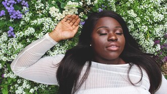 A woman lying on the grass, relaxing, feeling good with herself