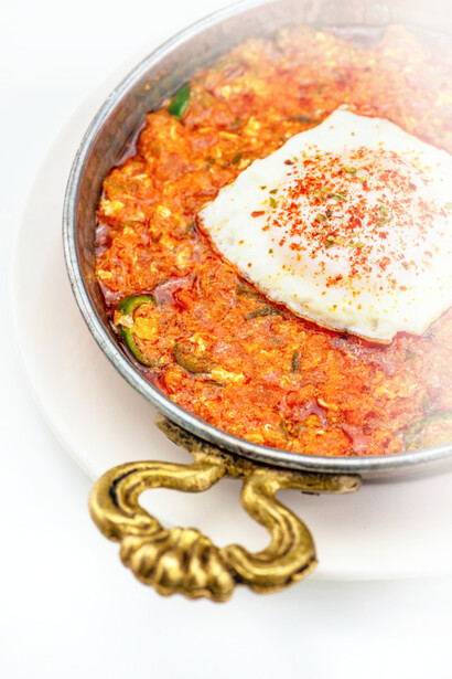 Shakshuka is a North African, Middle Eastern and Israeli meal of poached eggs in a simmering tomato sauce that is usually spicy