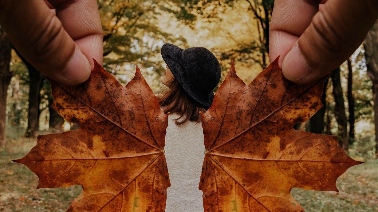 Leaves being used as wings to creatively give the person the power of flight