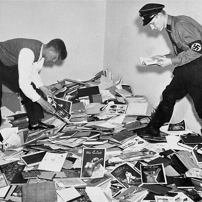 A German student and Nazi officer plunder the library of Dr. Magnus Hirschfeld in Berlin, 1933