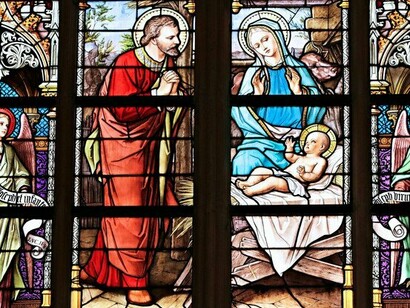 Colourful stained glass windows portraying the nativity scene, reflecting Christianity’s visible and institutional presence in African society