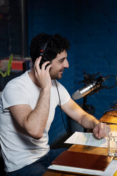 A man working in a studio with a microphone and headphones, focusing on subtitles and dubbing
