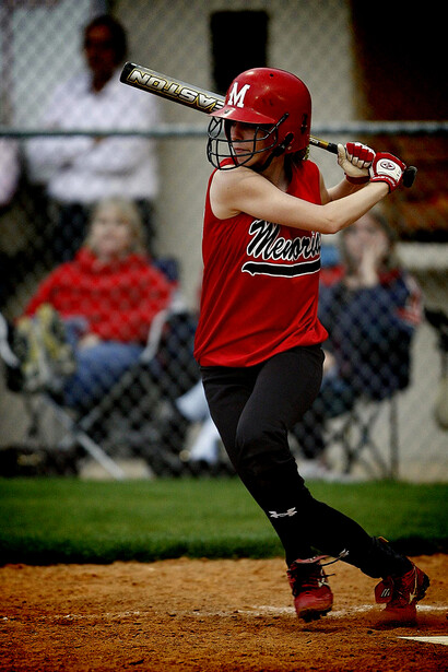 Woman preparing to bat during a women’s baseball match