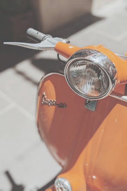 Orange motorcycle on gray concrete road