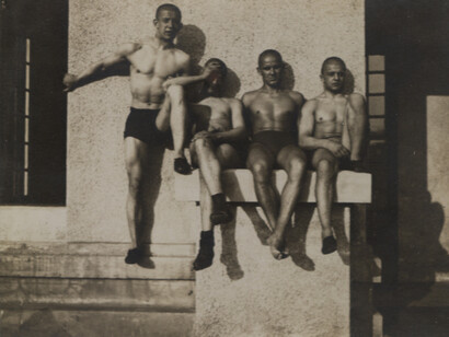 André Kertész (1894-1985), Group of four men in trunks sitting on a ramp, 1914, gelatin silver print, printed c. 1914, 3x4 1/8 in, dated on verso. Courtesy of Bruce Silverstein Gallery