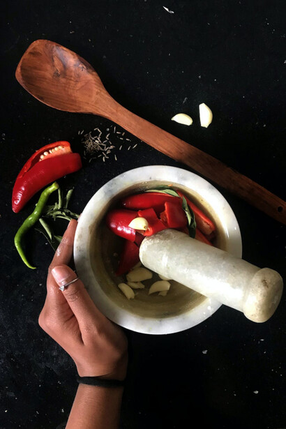 A mortar and pestle to grind up peppers, garlic and spices