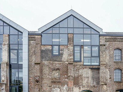 An aged brick warehouse transformed with contemporary interventions, presenting the reinvention of industrial spaces