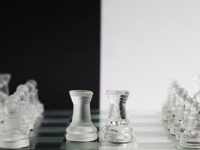 Elegant transparent chess pieces on a classic chessboard for a modern look