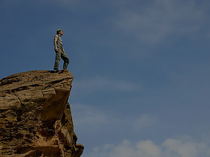 With skill and finesse, the man ascended the rocks on the mountain