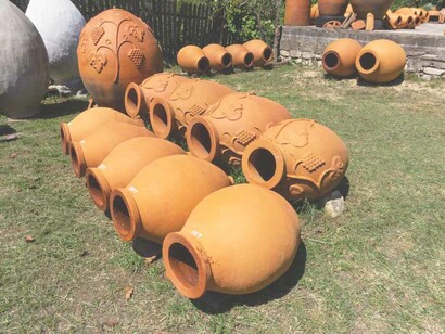 Rows of mini orange Qvervis lined up in this artisanal area in the rural part of Georgia